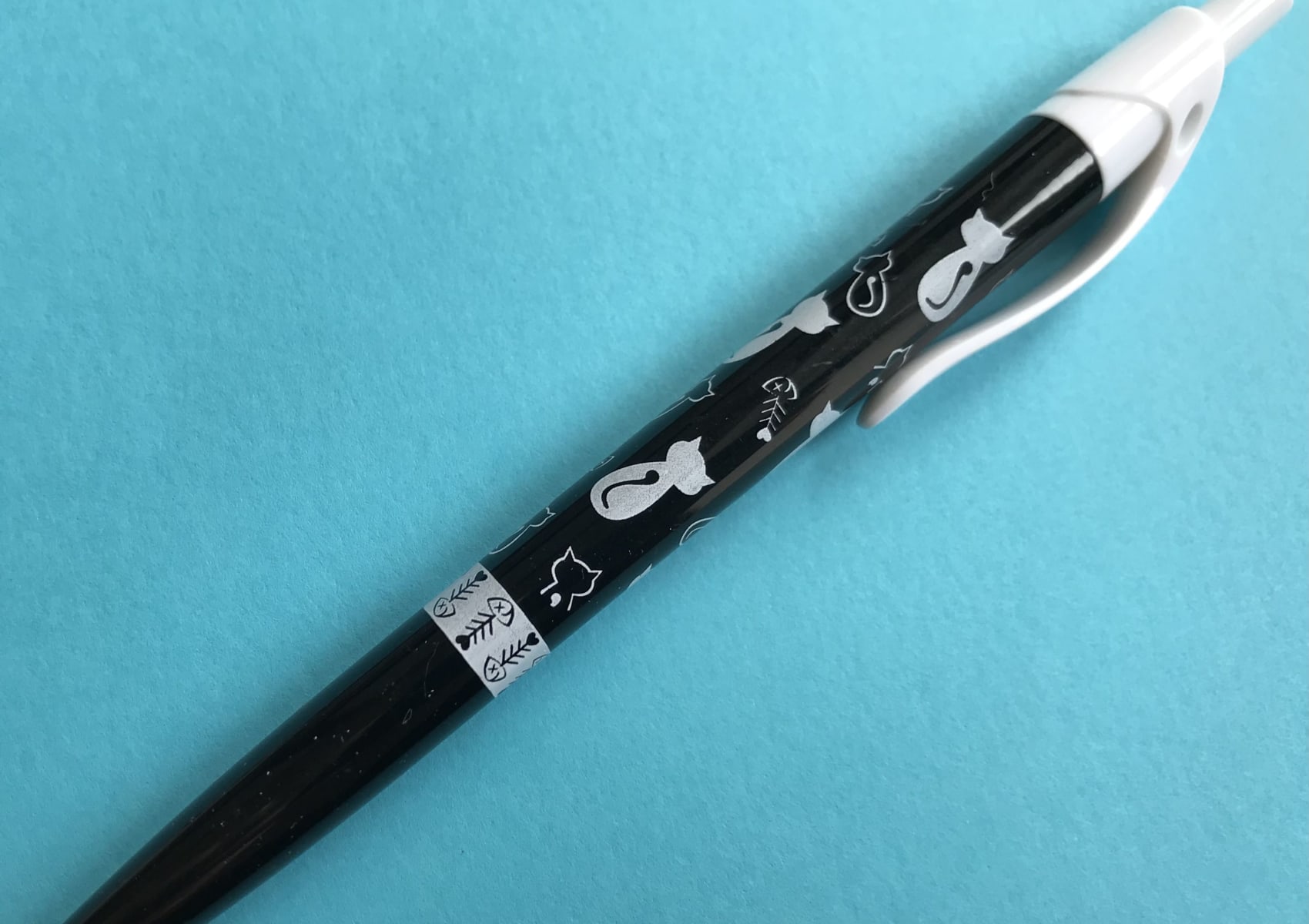 Black click pen with black and white cat designs