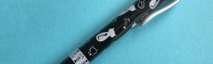 Black click pen with black and white cat designs