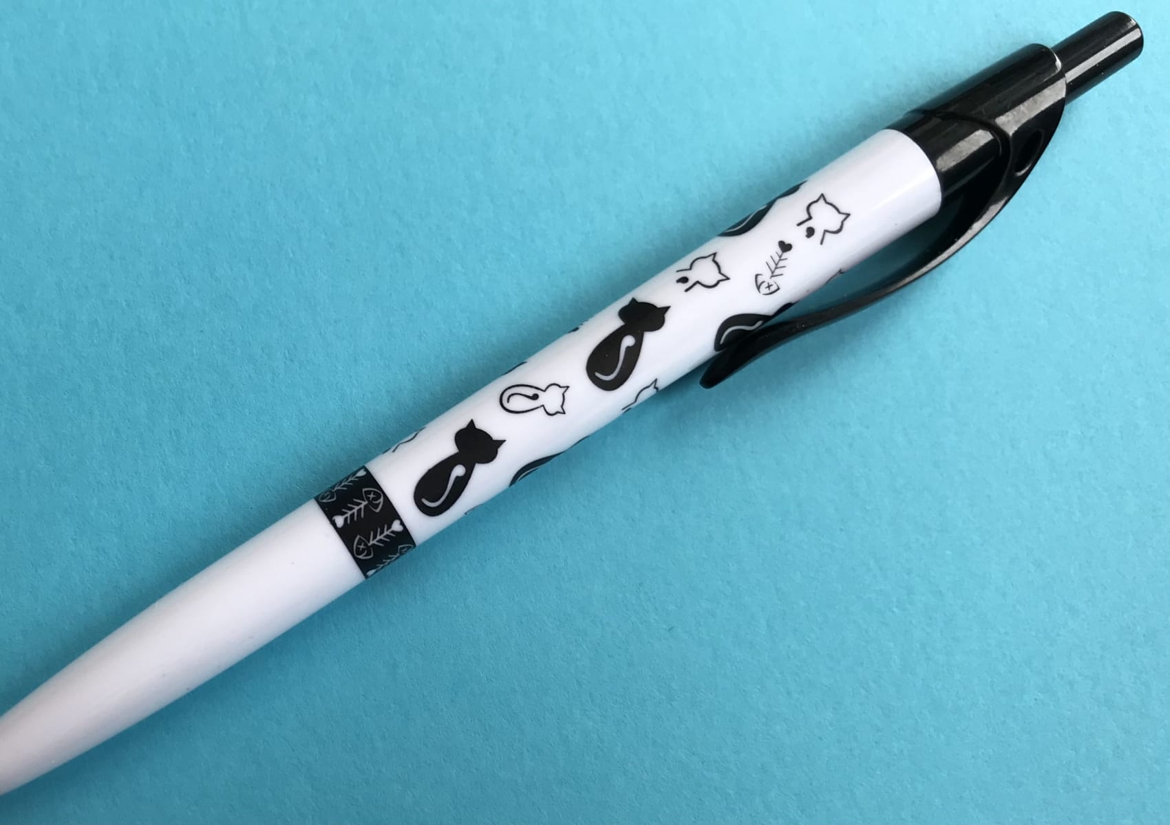 White pen with cat designs