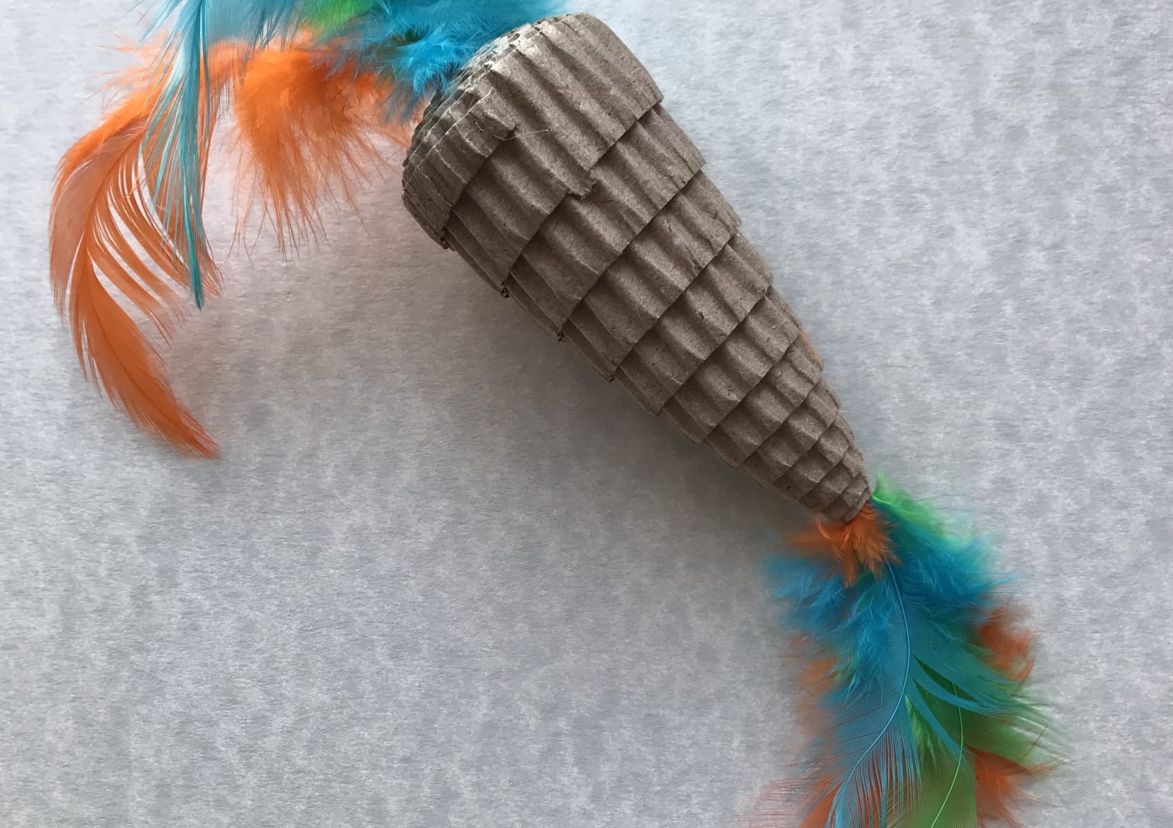 Sturdy cardboard and feather cat toy shaped like a pineapple
